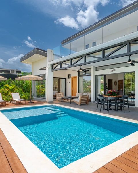 Modern Ohana vacation home with a private pool, wood deck, and open-air living space
